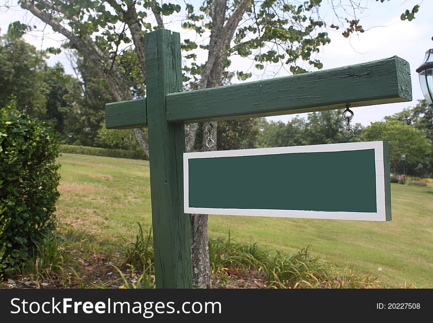 Blank sign in a beautiful rural setting. Write your own message.