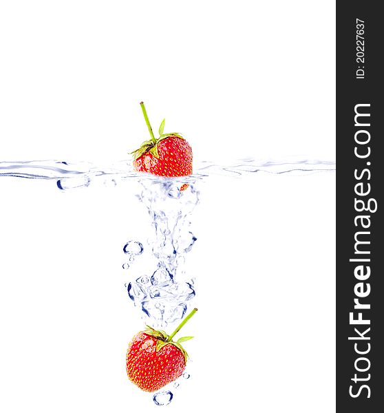 A background of bubbles forming in water after strawberries are dropped into it. A background of bubbles forming in water after strawberries are dropped into it.