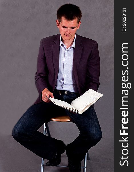 Businessman signing a contract on the grey background