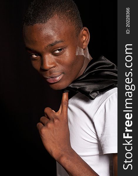 Portrait of a stylish black young fashion male model on black background. Portrait of a stylish black young fashion male model on black background.