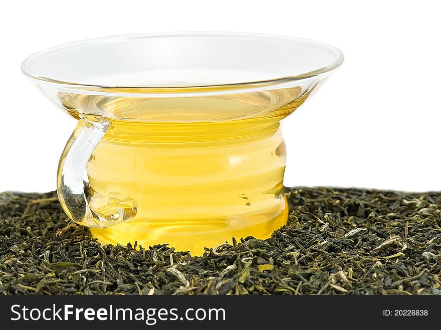 Cup of green tea with tea leaves on white