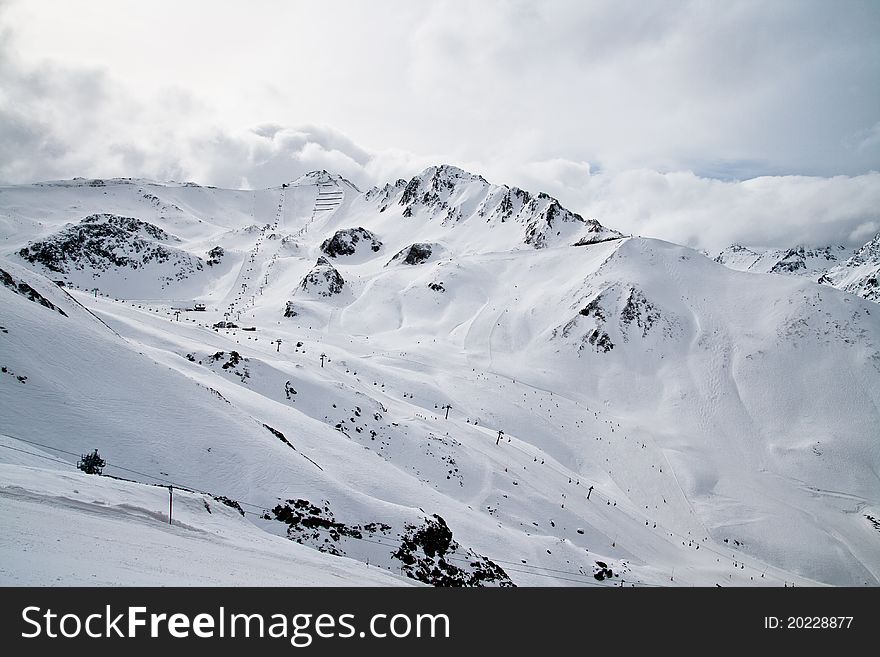 Panorama of Alpine ski resort with slopes, lifts and people. Panorama of Alpine ski resort with slopes, lifts and people
