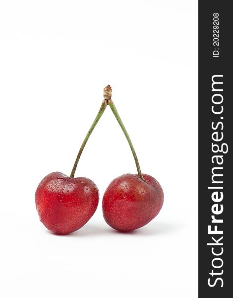 Two Fresh sweet red cherries isolated on white background. Two Fresh sweet red cherries isolated on white background