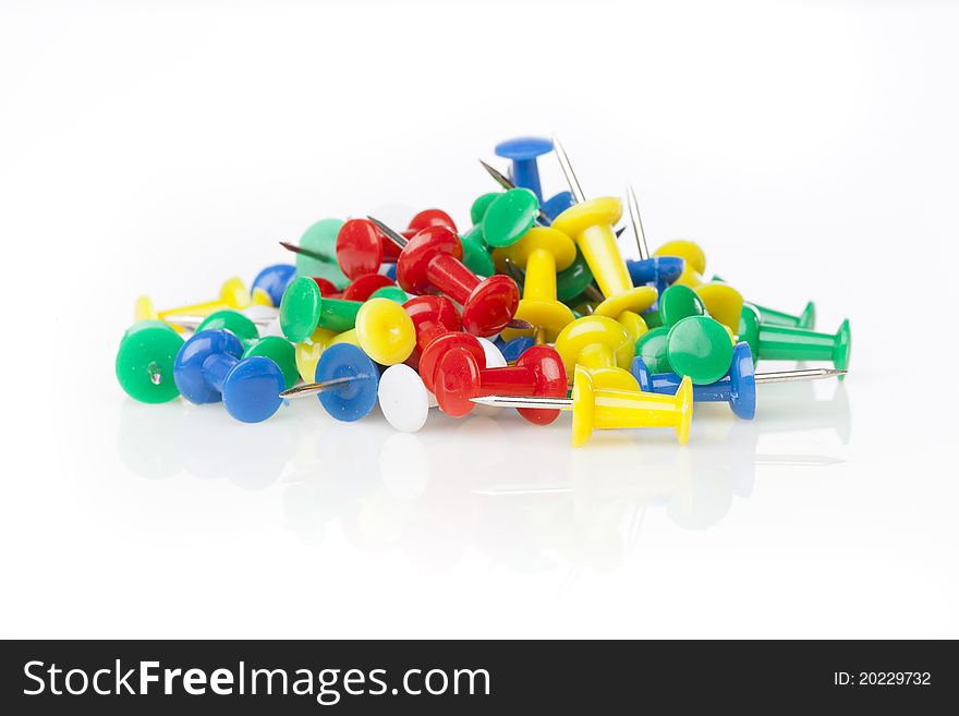 A colorful thumb tack against a white background