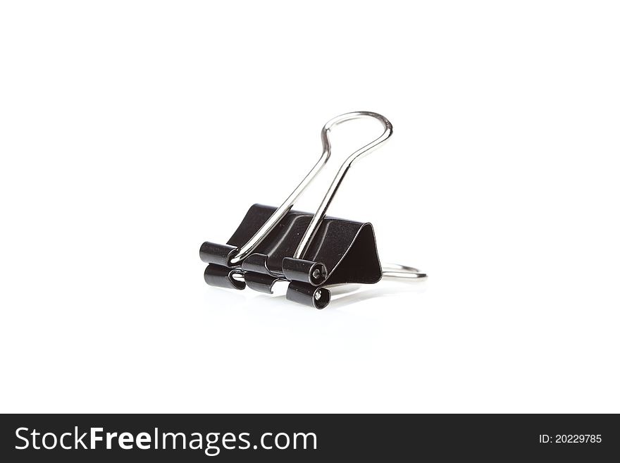 A black binder clip against a white background