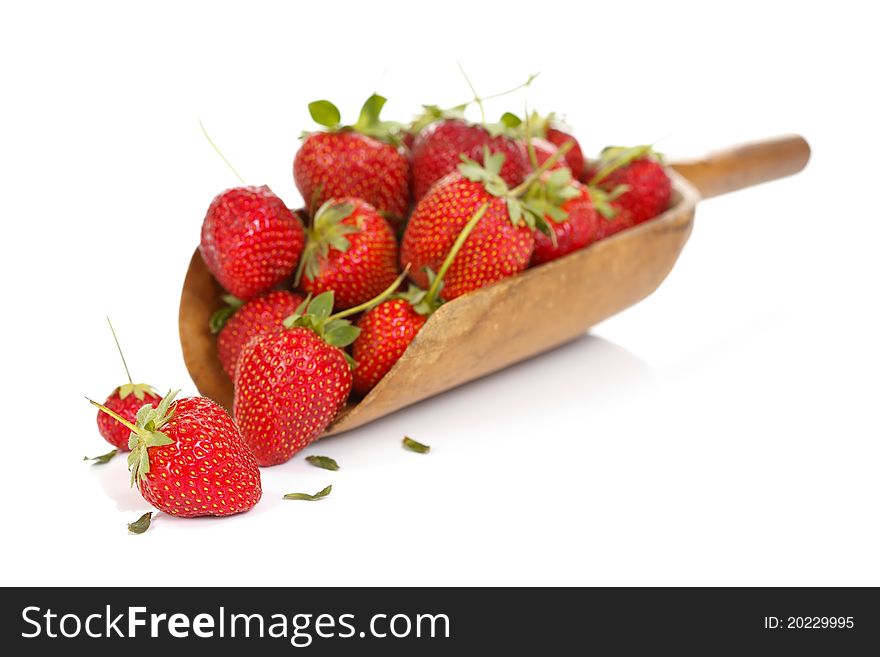 Fresh strawberries with a wooden spoon