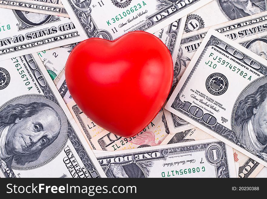 Red heart on top of dollar bank notes. Red heart on top of dollar bank notes