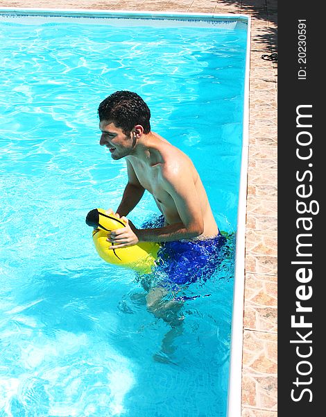 Man with yellow banana in swimming pool. Man with yellow banana in swimming pool.