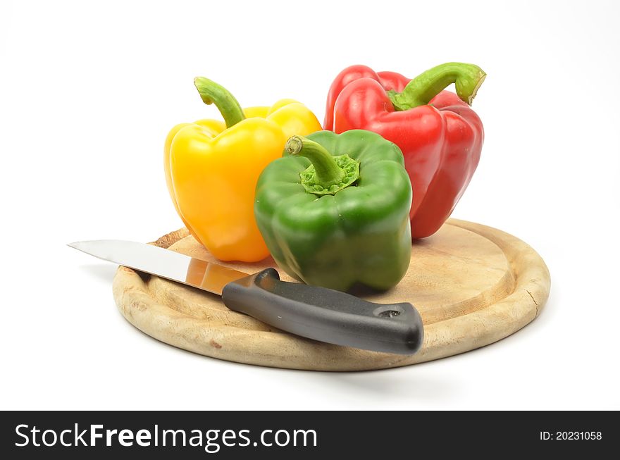 Fresh colorful paprika and knife on wood block