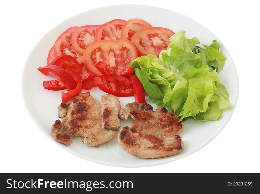 Fried pork with salad on an white plate