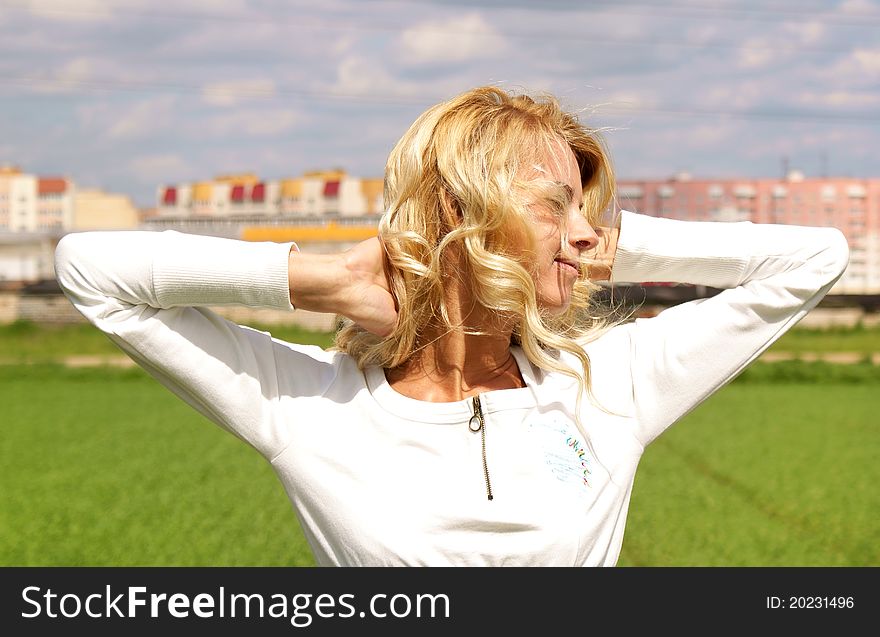 Smiling blondy young girl relaxing. Smiling blondy young girl relaxing