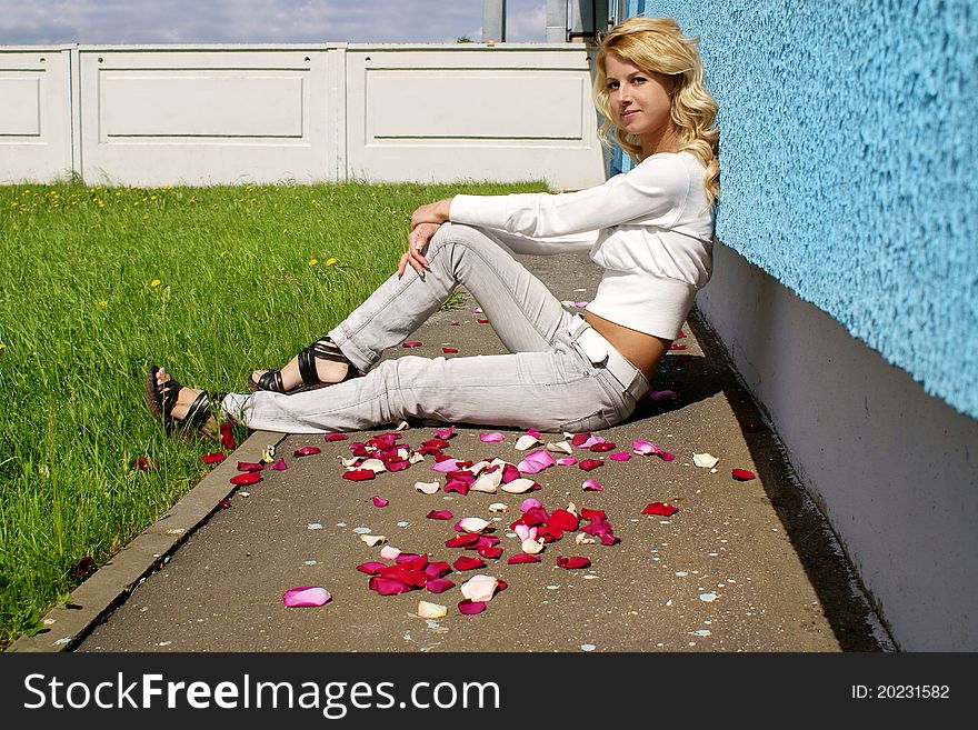 Blondy pretty girl in petails of roses. Blondy pretty girl in petails of roses