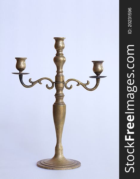 Brass candlestick on white background