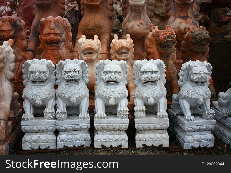 China stone lion group, in stone sculpture as the background.