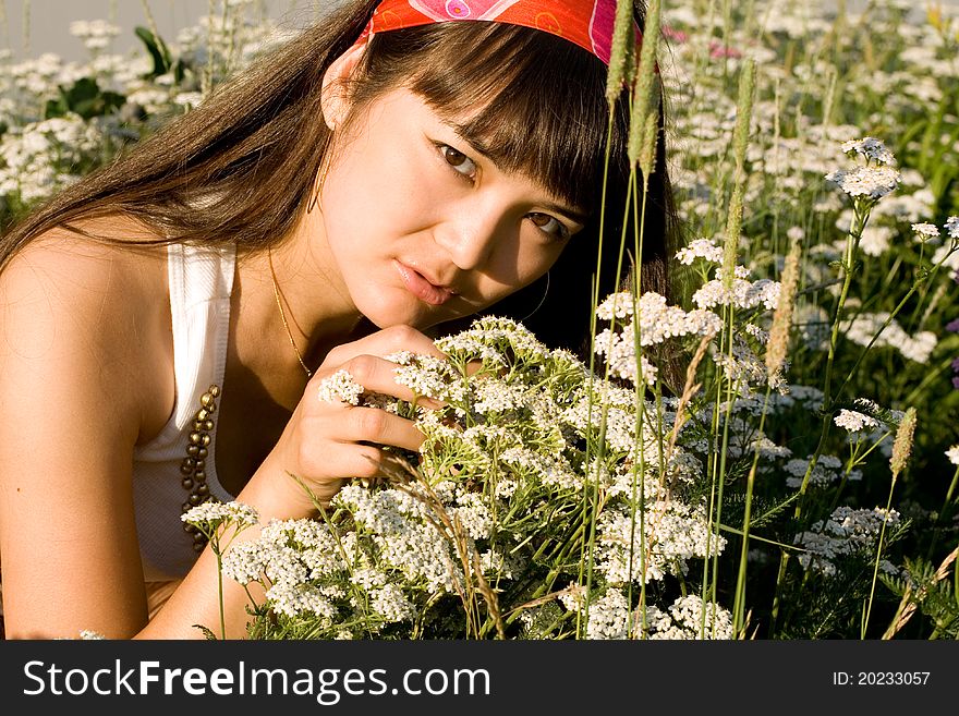 Beautiful Girl Sitting On Meadow