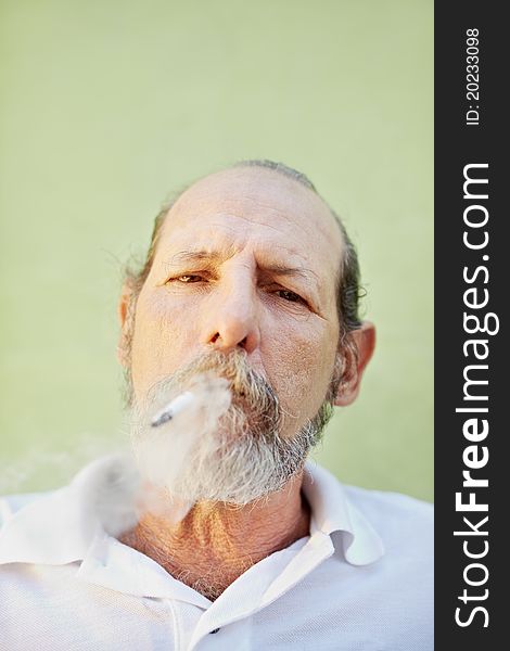 Aged caucasian man smoking cigarette