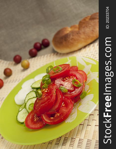 A vegetable salad on a  green plate