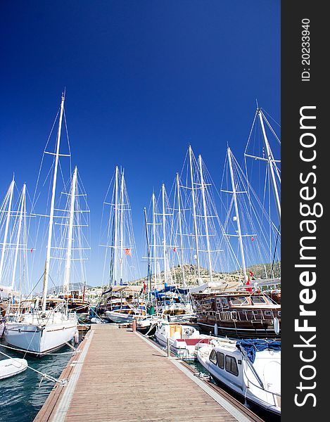 Yachts on the harbor next to quay.