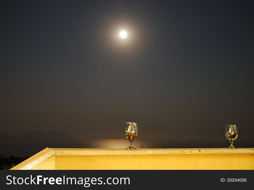 Romantic Scene of Wineglass and Full Moon with Sea at Background