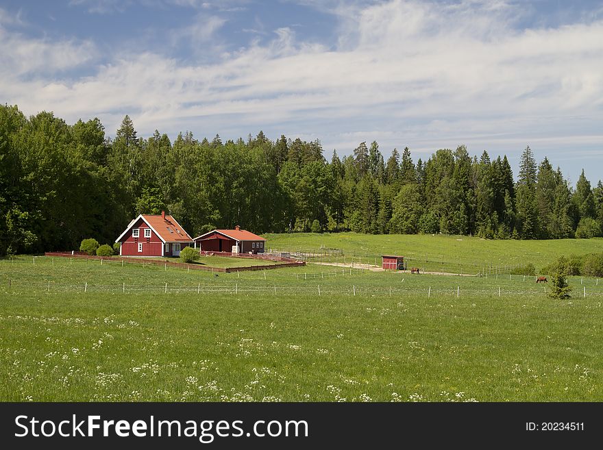 Traditional Scandinavian country house and corral for horses. Traditional Scandinavian country house and corral for horses