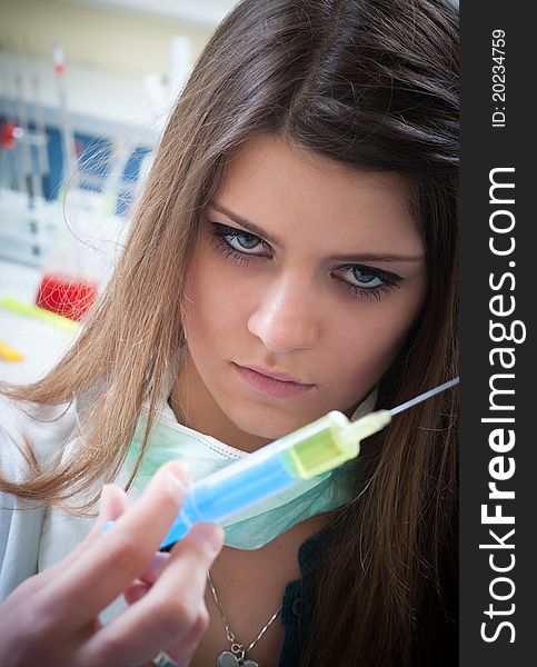 Young beautiful woman with syringe in her hand. Young beautiful woman with syringe in her hand