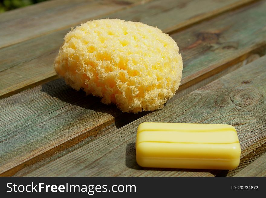 Yellow sponge and soap on wood panels
