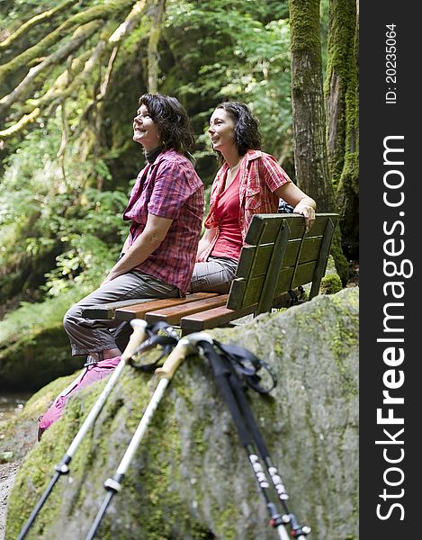 Mother and daughter doing a break while hiking