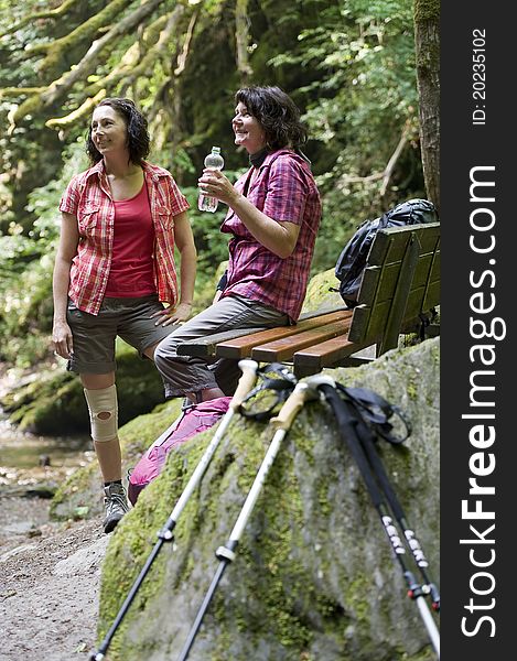 Mother and daughter doing a break while hiking