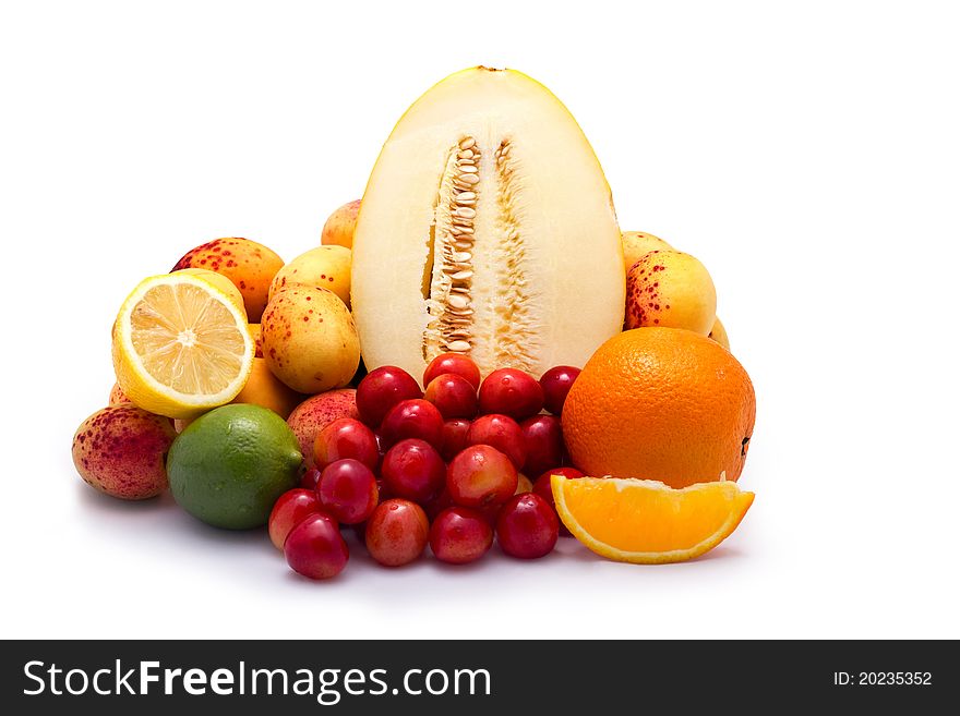 Fruit selection with melon, apricots, cherry, lemon, lime and orange isolated on white background. Fruit selection with melon, apricots, cherry, lemon, lime and orange isolated on white background