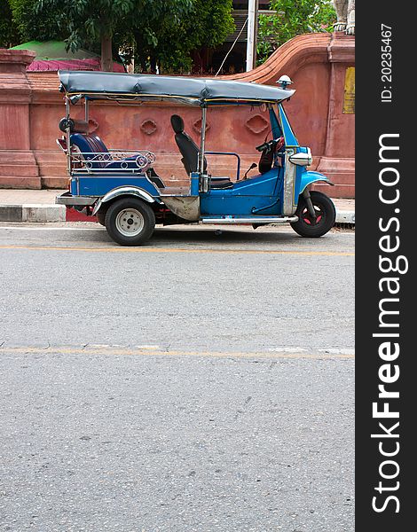 Thai tuk tuks sit parked awaiting tourists