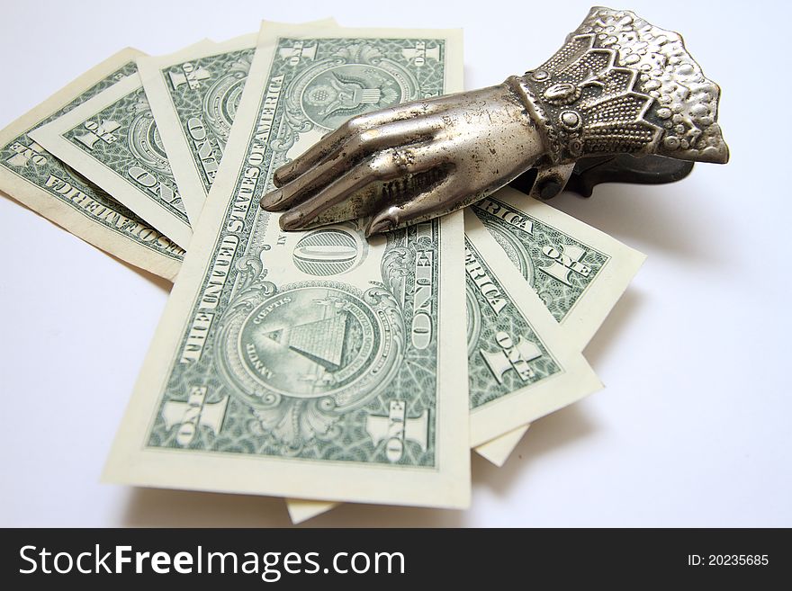 Dollars in a clothespin-holder, against a light background