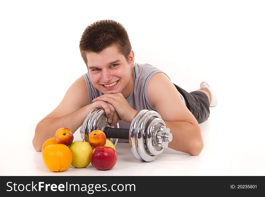 Portrait of a young man with weights and fresh fruits. Portrait of a young man with weights and fresh fruits