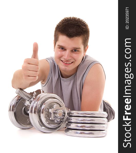 Young man exercising with a dumbbell and pointing OK