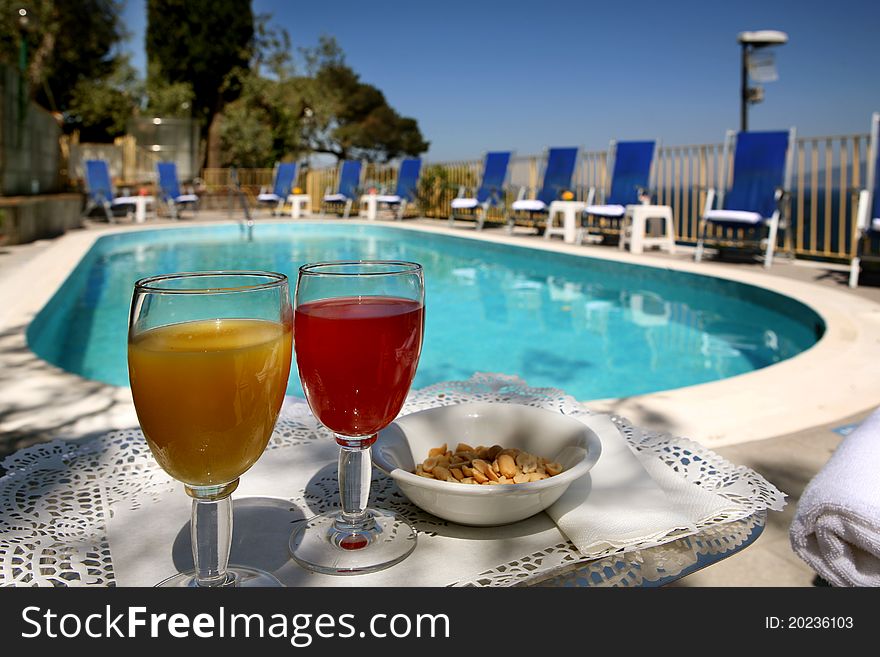 Swimming pool for hotel with deckchairs