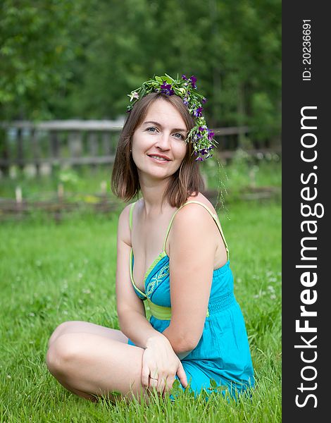 Young women sit on grass