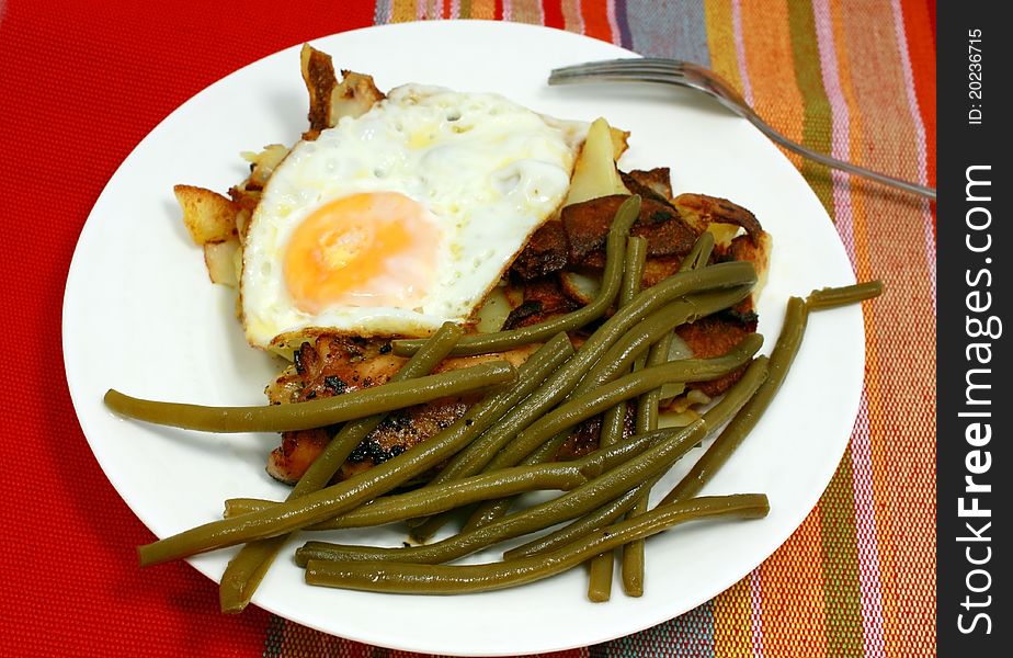 French bean and scrambled egg and fried popato on the plate. French bean and scrambled egg and fried popato on the plate