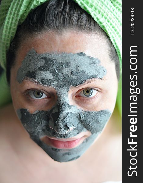 Close-up of a woman with a clay mask. Close-up of a woman with a clay mask