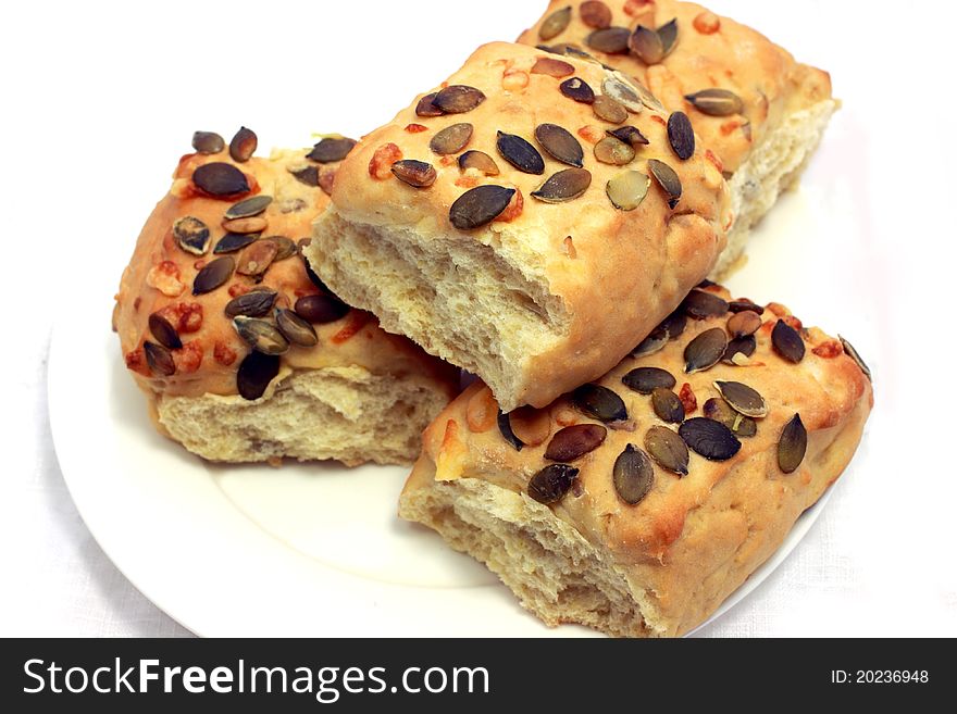 Small bread with pumpkin seeds close up isolated