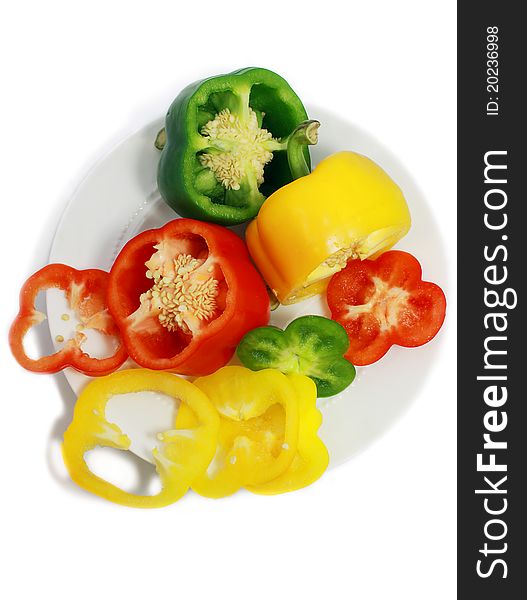 Cut sweet peppers on the plate isolated