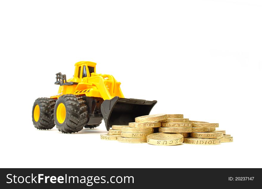 Toy construction truck next to a heap of coins. Toy construction truck next to a heap of coins