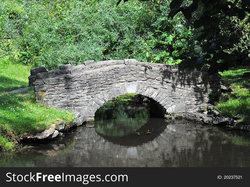 An old stone bridge for path over a creek. An old stone bridge for path over a creek