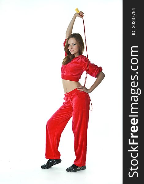 The slender girl in a red tracksuit, aspiring to do exercises