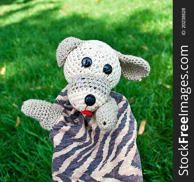Funny hand puppet of dog on green. Funny hand puppet of dog on green