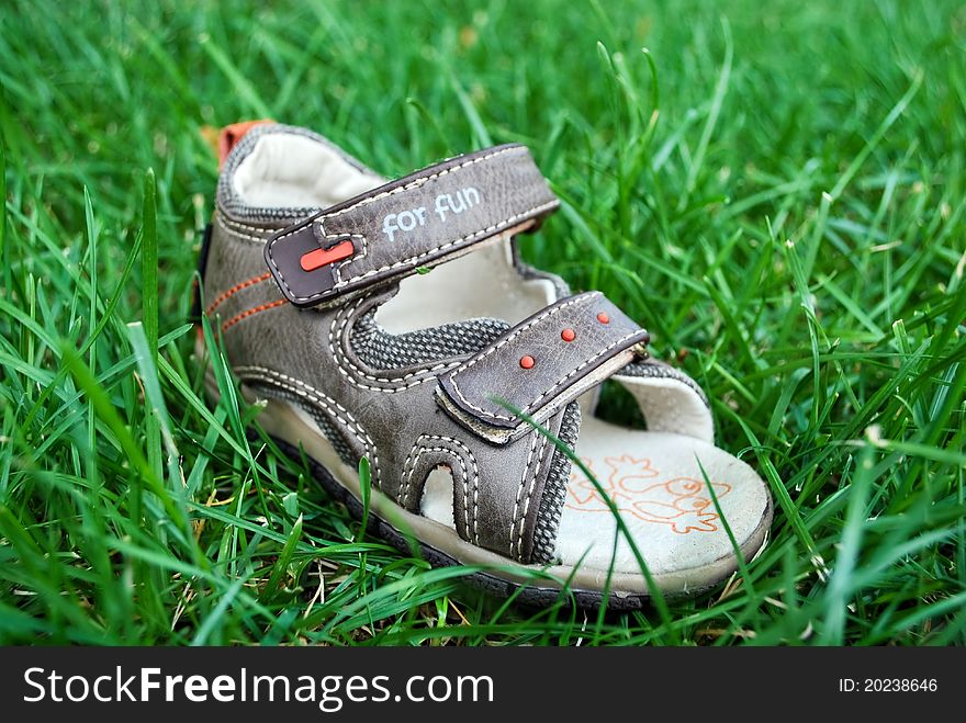 Kids shoes for fun in green grass