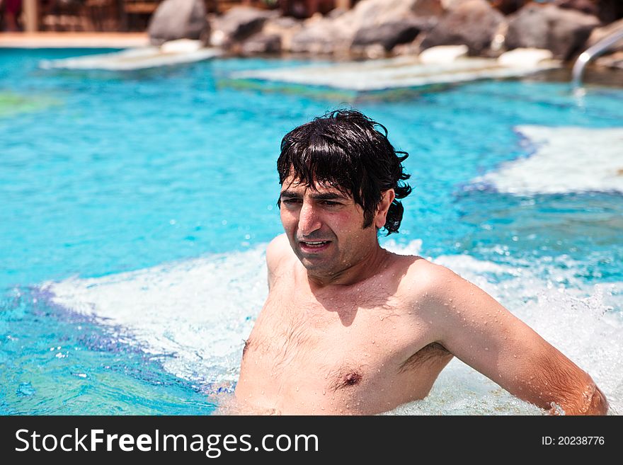 Man relaxing in jacuzzi at swimming-pool