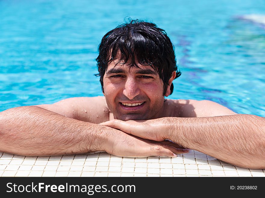 Man smiling and relaxing in swimming-pool. Man smiling and relaxing in swimming-pool