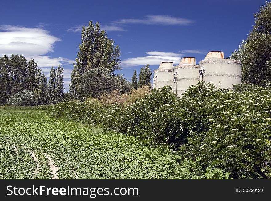 Old white water tanks against the blue sky. Old white water tanks against the blue sky