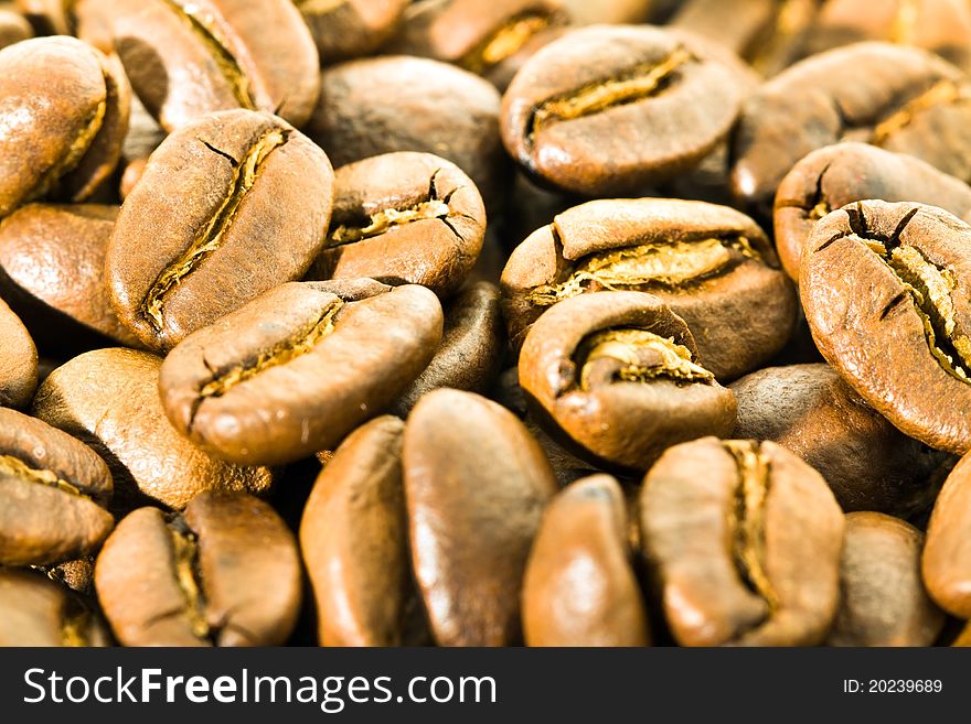 The background made of a heap of grains of coffee (Small depth of sharpness). The background made of a heap of grains of coffee (Small depth of sharpness)