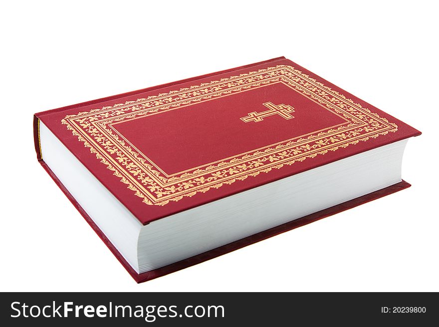 The red orthodox bible with a cross and on a white background (focus on a cross). The red orthodox bible with a cross and on a white background (focus on a cross)