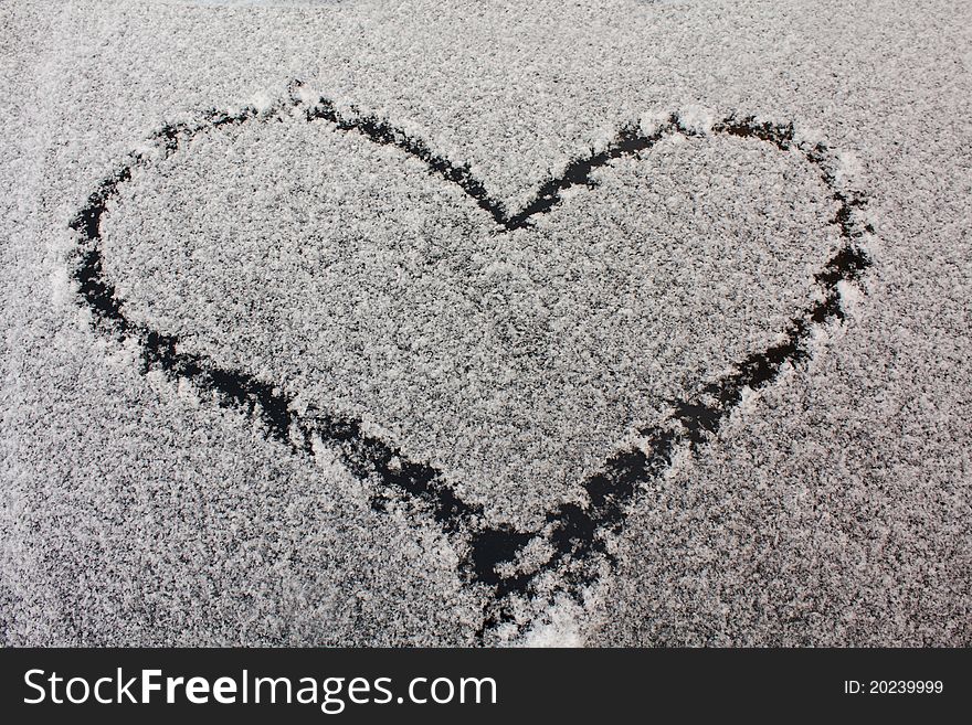 The heart drawn on snow (snow lies on a car cowl). The heart drawn on snow (snow lies on a car cowl)